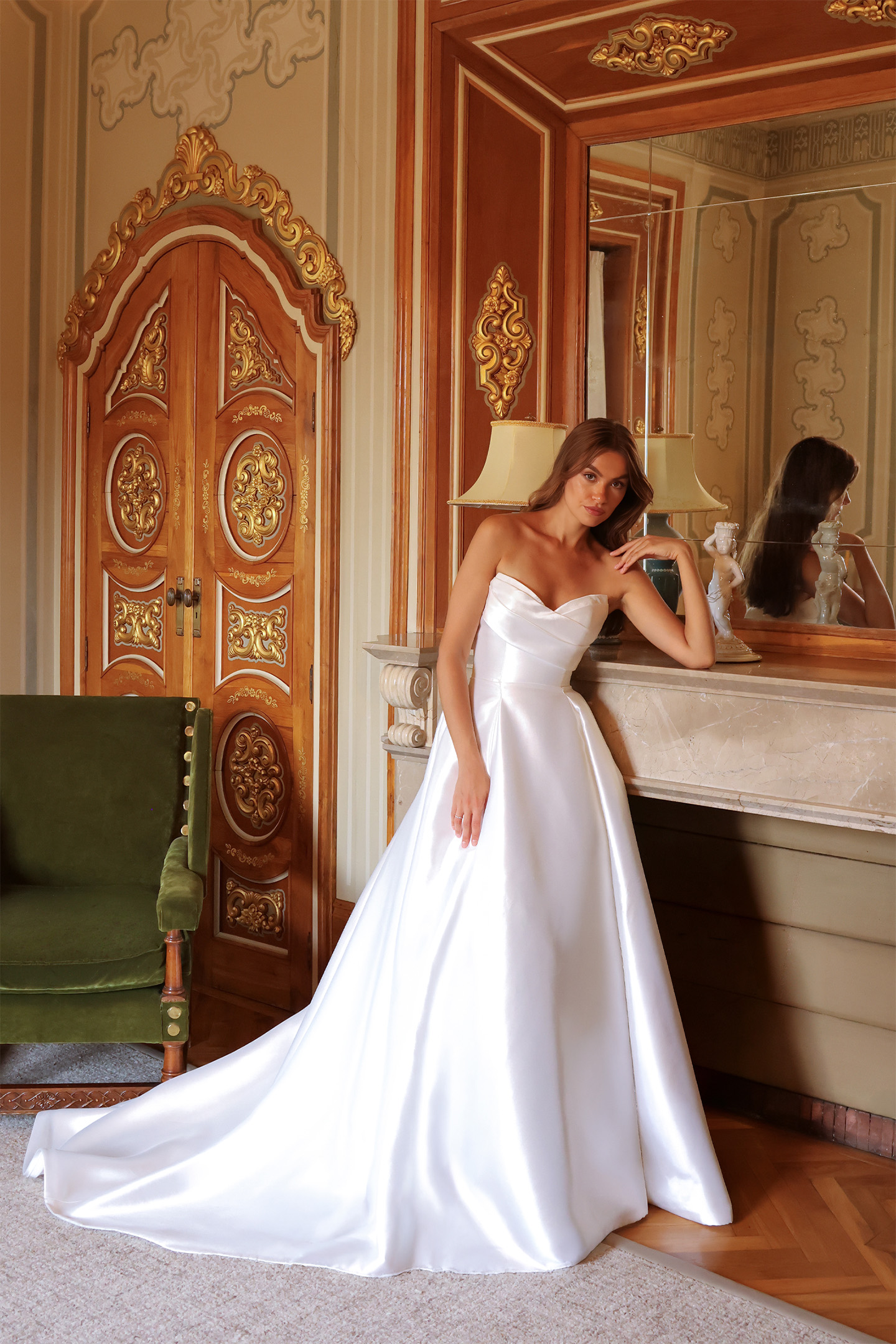 Robe de mariée Darlène en mikado portée dans un fauteuil de style.